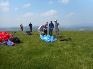 Mark teaching students how to pack a paraglider correctly